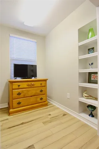 a view of staircase with wooden floor and white walls