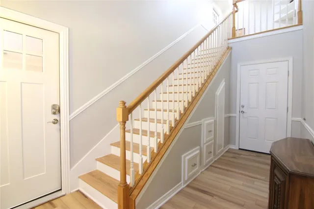 a view of entryway and hall with wooden floor