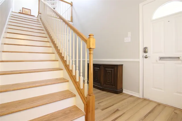 a view of an entryway with wooden floor
