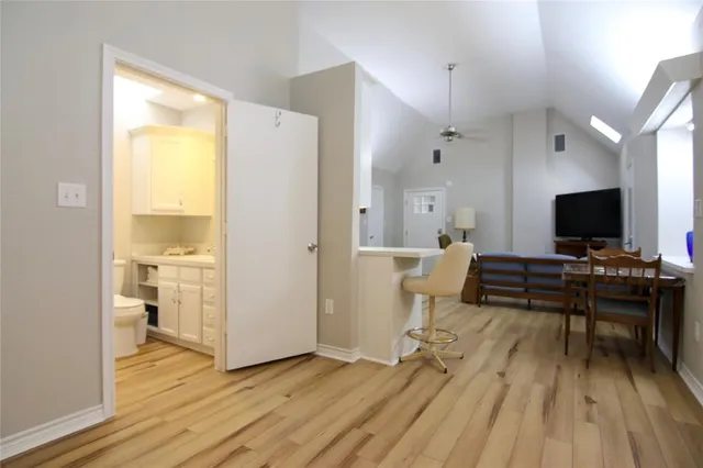 a workspace with wooden floor and a window