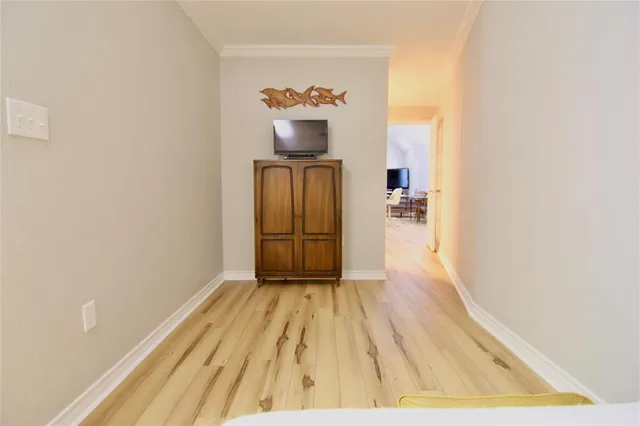 a view of a hallway view with wooden floor and a chandelier