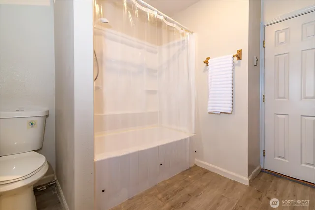 a bathroom with a shower and a toilet