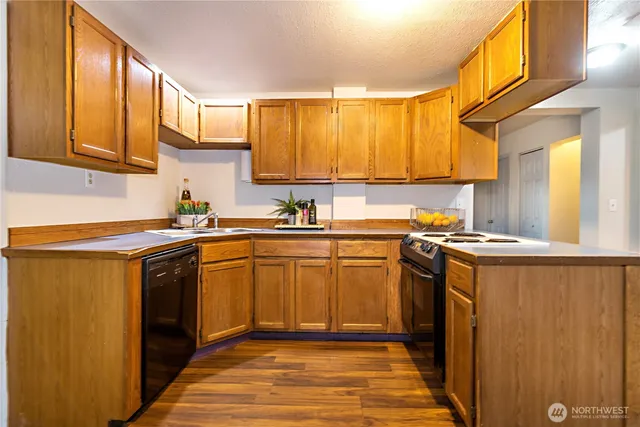 a kitchen with stainless steel appliances granite countertop a refrigerator sink and cabinets