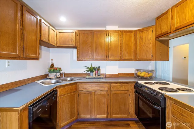 a kitchen with a sink stove and cabinets