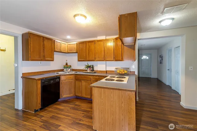 a kitchen with stainless steel appliances granite countertop a sink and stove top oven
