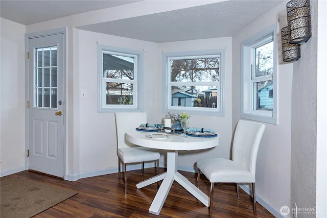 a view of a dining room with furniture window and wooden floor