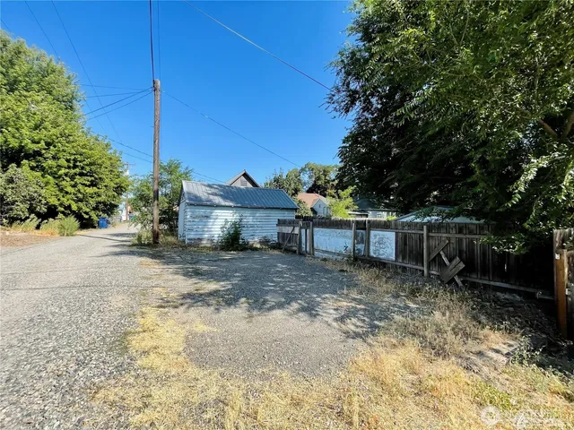 a view of a house with a yard and tree