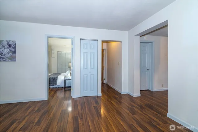 a view of a room with wooden floor