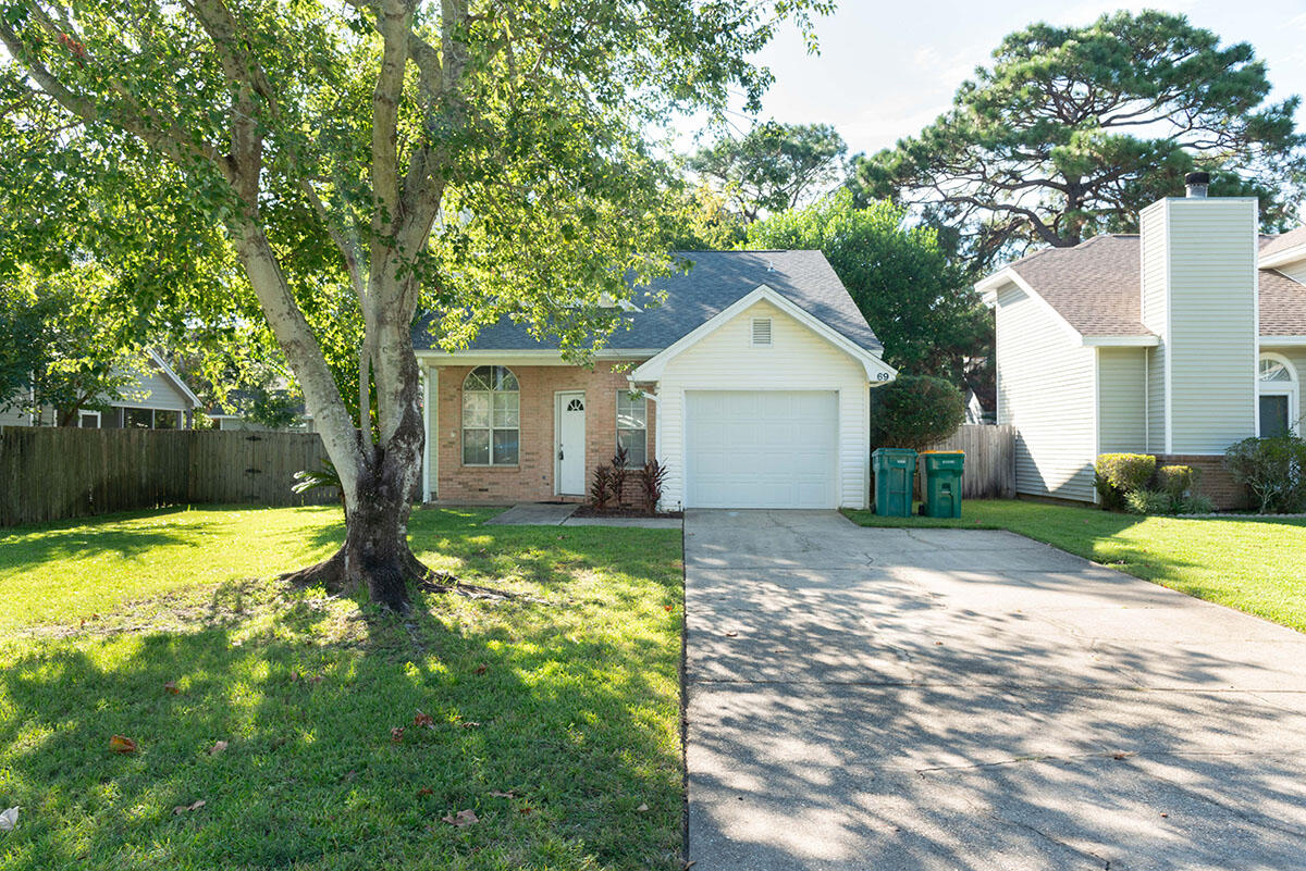 a view of a house with yard and sitting area