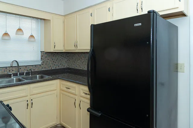 a kitchen with a refrigerator and cabinets