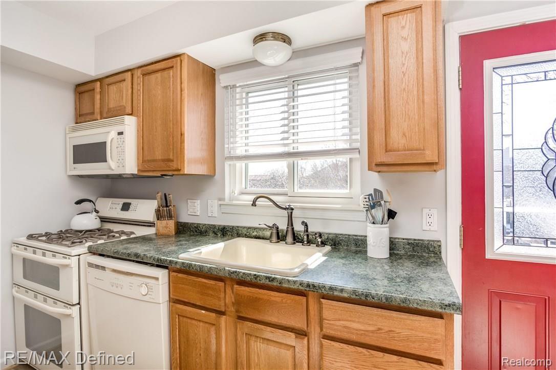 440 Miller Avenue, Unit 35 Rochester, MI 48307 - Photo 7 of 16 Kitchen offers space plus natural light with a view of the back yard along with a bright back entrance
