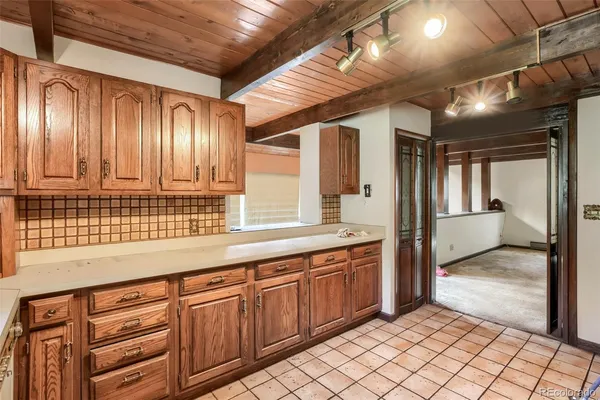 a kitchen with granite countertop a sink and cabinets