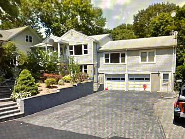 a house with lots of trees in the background