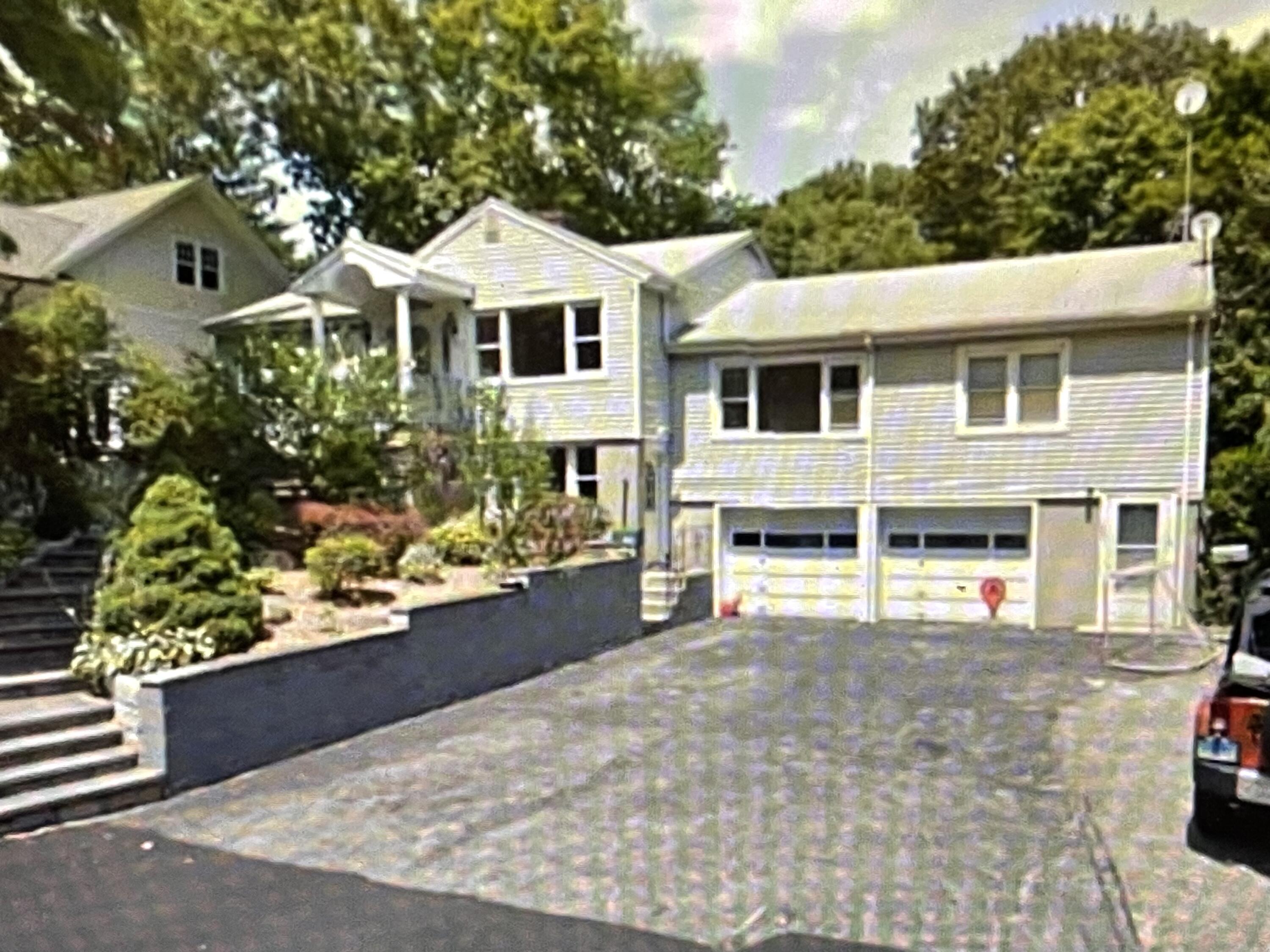 a house with lots of trees in the background