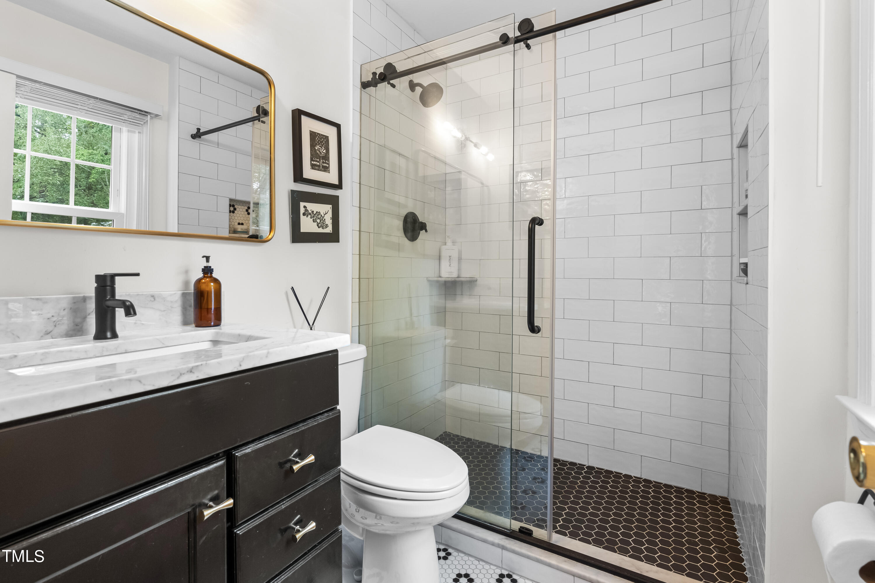 2919 Wycliff Road Raleigh, NC 27607 - Photo 11 of 24 a bathroom with a sink toilet a shower and a mirror