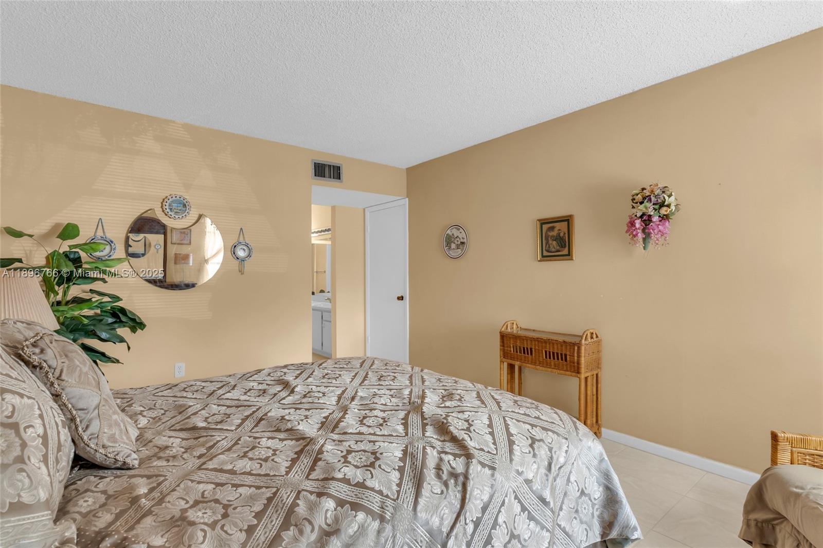 5800 Southwest 127th Avenue, Unit 2203 Miami, FL 33183 - Photo 14 of 32 a bedroom with a bed and a potted plant