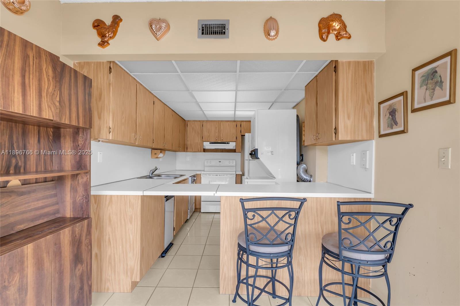 5800 Southwest 127th Avenue, Unit 2203 Miami, FL 33183 - Photo 9 of 32 a kitchen with stainless steel appliances granite countertop a sink and cabinets