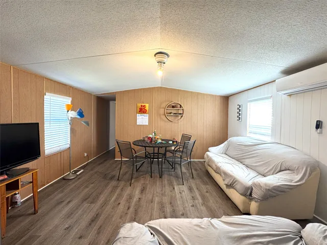 a view of a livingroom with furniture and a flat screen tv