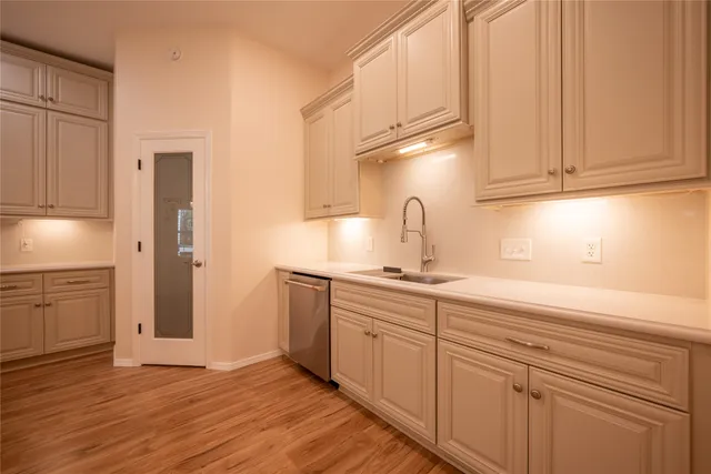 a kitchen with a sink cabinets and appliances