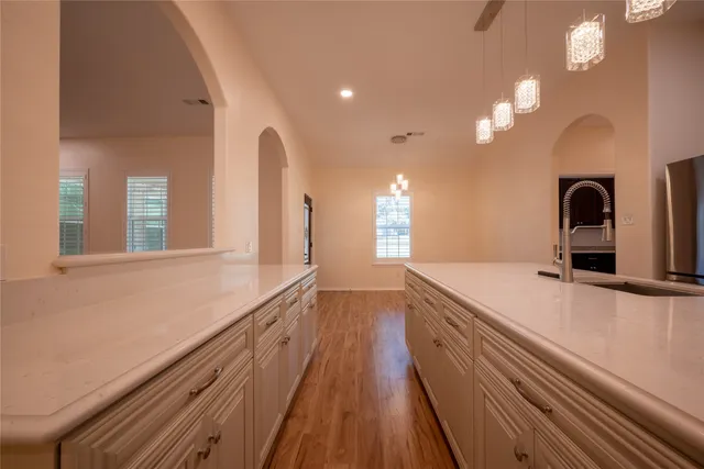 a spacious bathroom with a sink and a large mirror