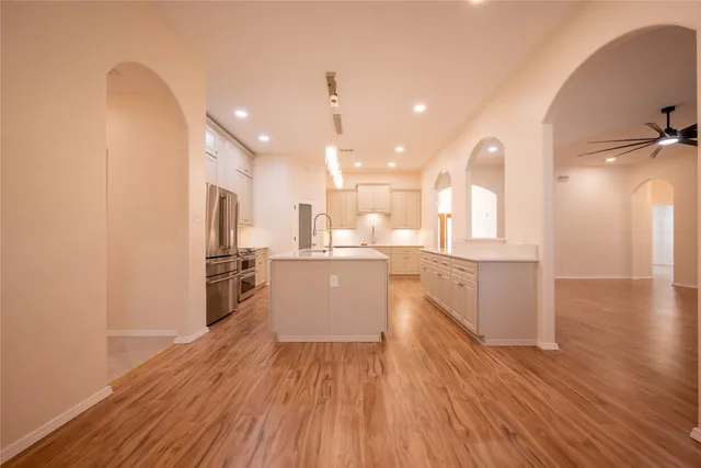 a view of a kitchen with wooden floor and a sink