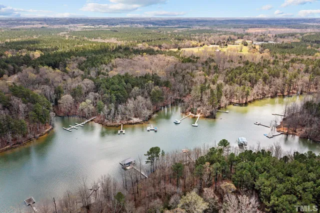 an aerial view of ocean and residential houses with outdoor space