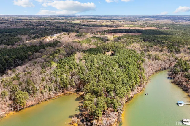 an aerial view of a houses with ocean view