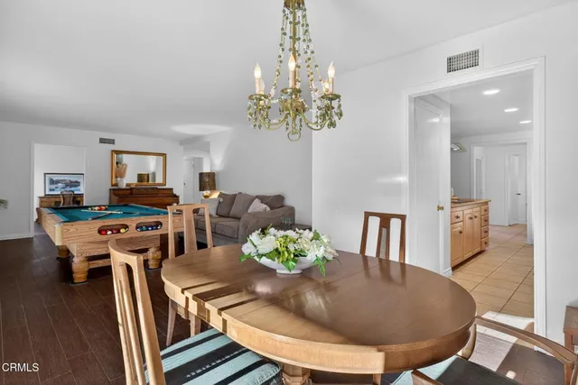 a living room with furniture a rug and kitchen view