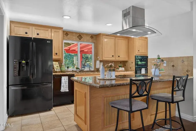 a kitchen with stainless steel appliances granite countertop a sink and a stove