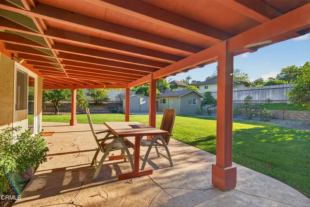 an aerial view of a house with a yard potted plants and large tree