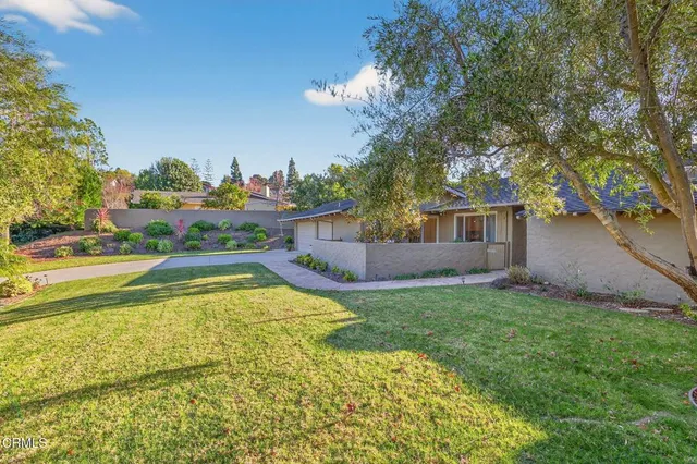 a view of house with swimming pool yard and outdoor seating