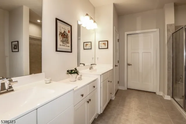 a bathroom with double vanity sinks and a mirror