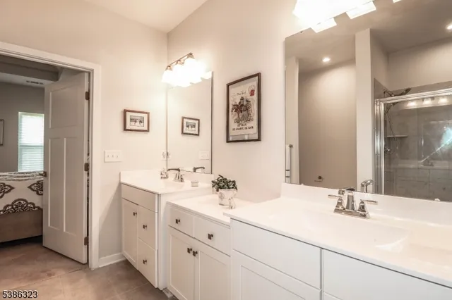 a bathroom with double sink and a mirror