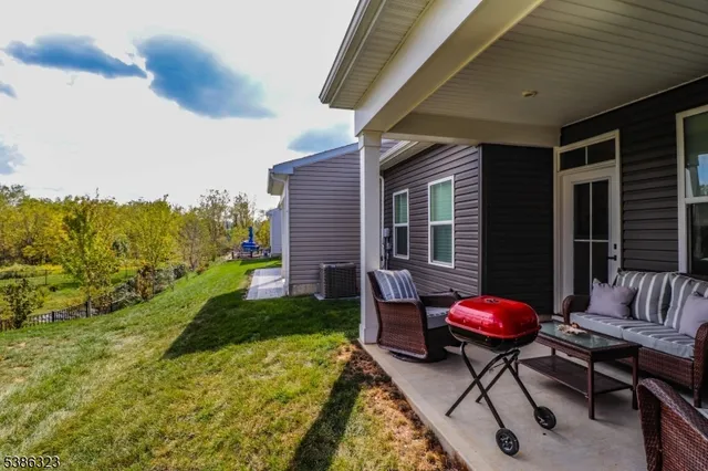 a backyard of a house with outdoor seating