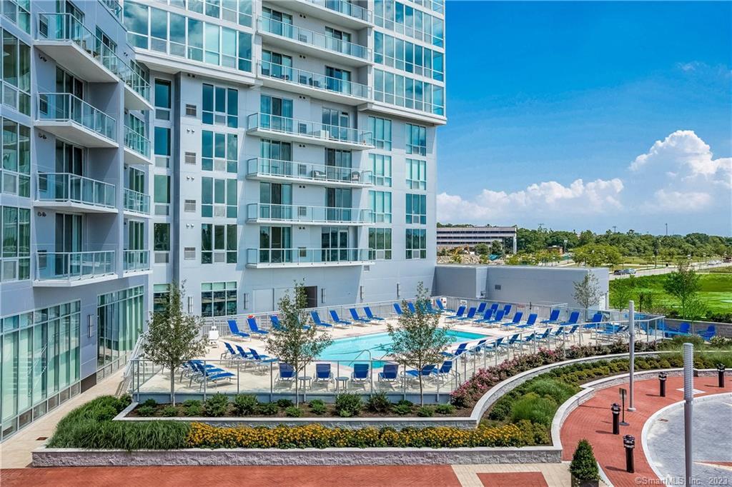 1 Harbor Point Road, Unit 313 Stamford, CT 06902 - Photo 13 of 13 a front view of a building with a garden and seating