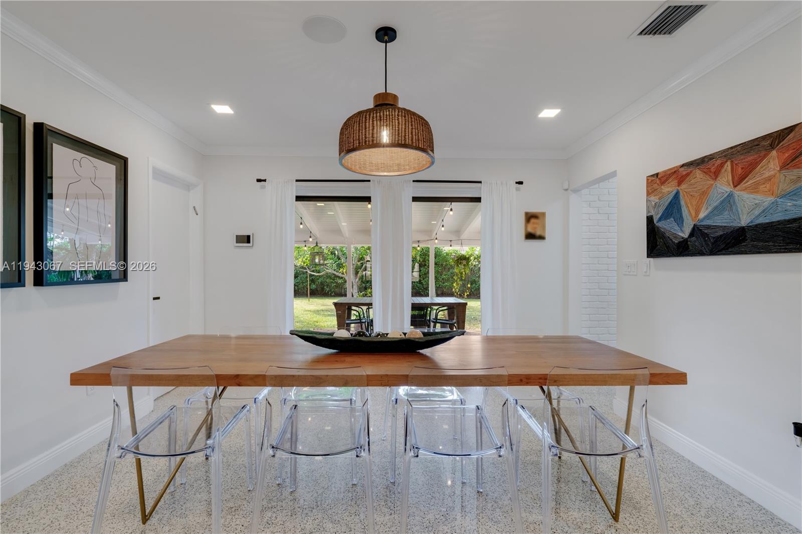 16102 Southwest 98th Avenue Miami, FL 33157 - Photo 12 of 36 Dine in your dining room while enjoying serene views of the private backyard and inviting covered terrace.