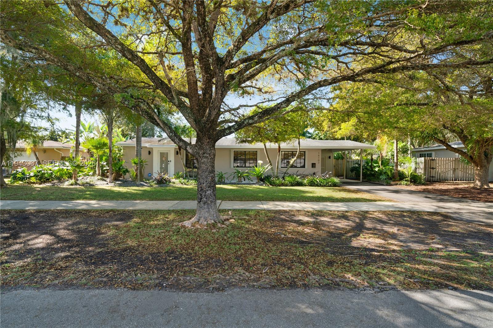 16102 Southwest 98th Avenue Miami, FL 33157 - Photo 2 of 36 A tropical, meticulously manicured oasis surrounds the home, offering a perfect blend of shade, sunshine, and beautifully lit landscaping in both the front and back yards.