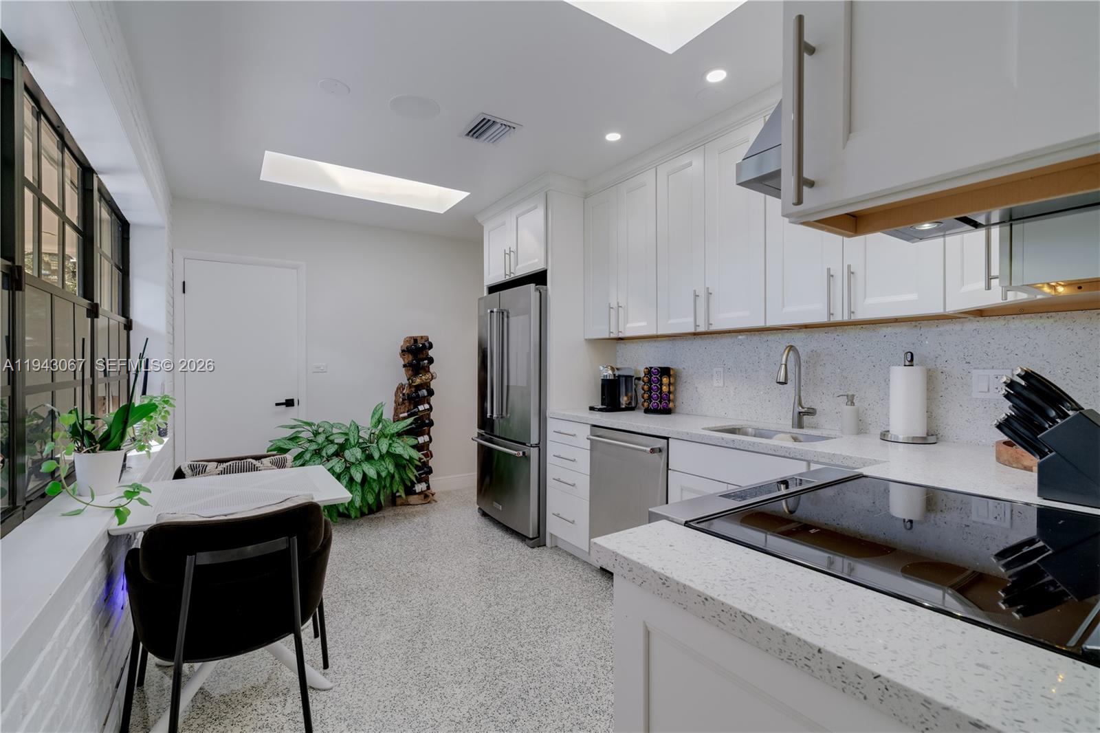 16102 Southwest 98th Avenue Miami, FL 33157 - Photo 22 of 36 A white, light, and airy kitchen featuring solid wood cabinets and sleek quartz countertops.