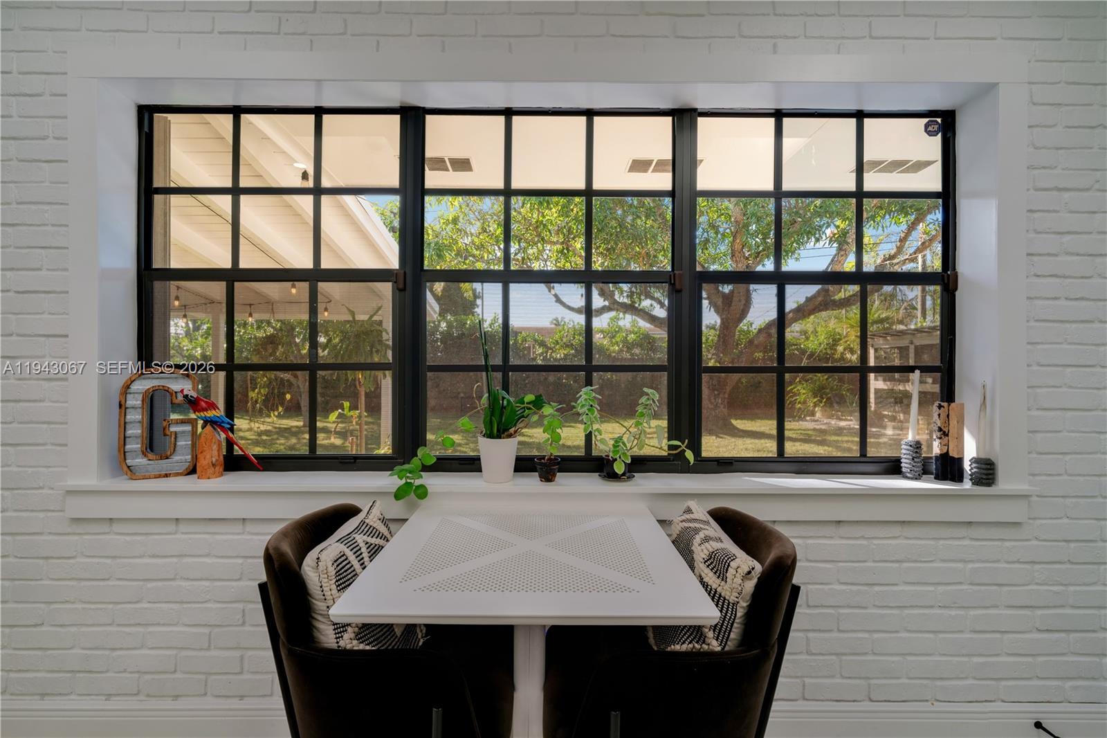 16102 Southwest 98th Avenue Miami, FL 33157 - Photo 25 of 36 Wake up to the perfect start to your day—enjoying breakfast and coffee in your kitchen with a tranquil, picture-perfect view of the lush backyard.