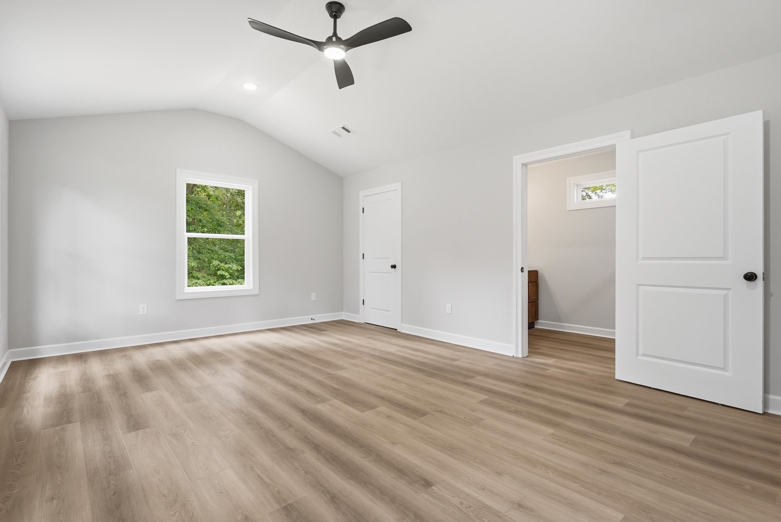4683 Belmont Road Hernando, MS 38632 - Photo 16 of 21 Spacious room featuring vaulted ceilings, wood-finish flooring, and a modern ceiling fan
