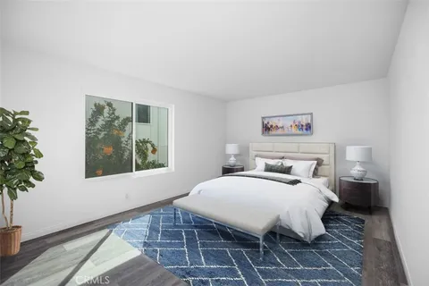 a living room with a bed furniture and a window