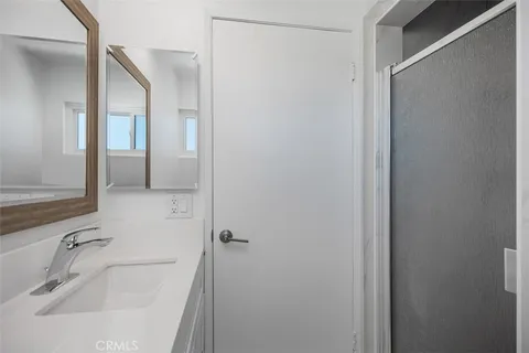 an empty room with wooden floor and window