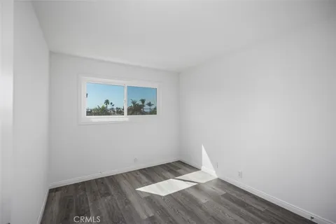 a front view of a building with palm trees