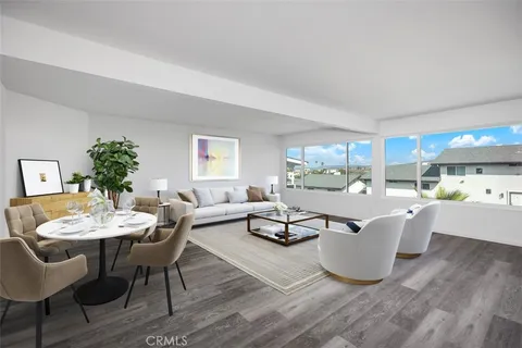a living room with furniture a potted plant and a table