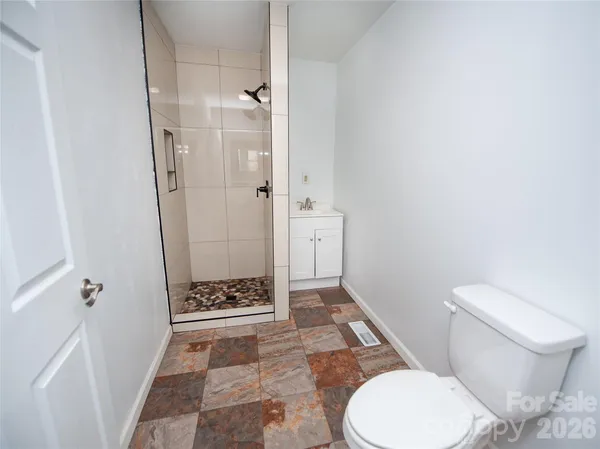 a bathroom with a toilet and a shower