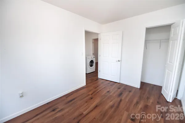 an empty room with wooden floor and closet