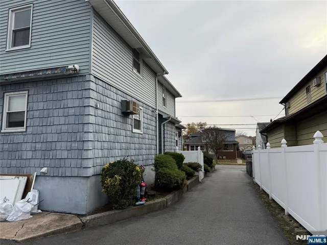 a backyard of a house with barbeque oven table and chairs