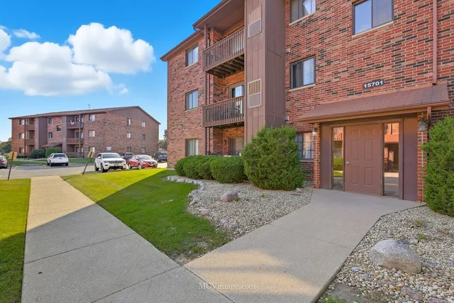 a view of a building with a garden and pathway