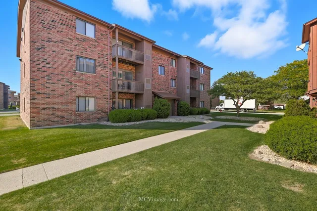 a brick building with a yard in front of it