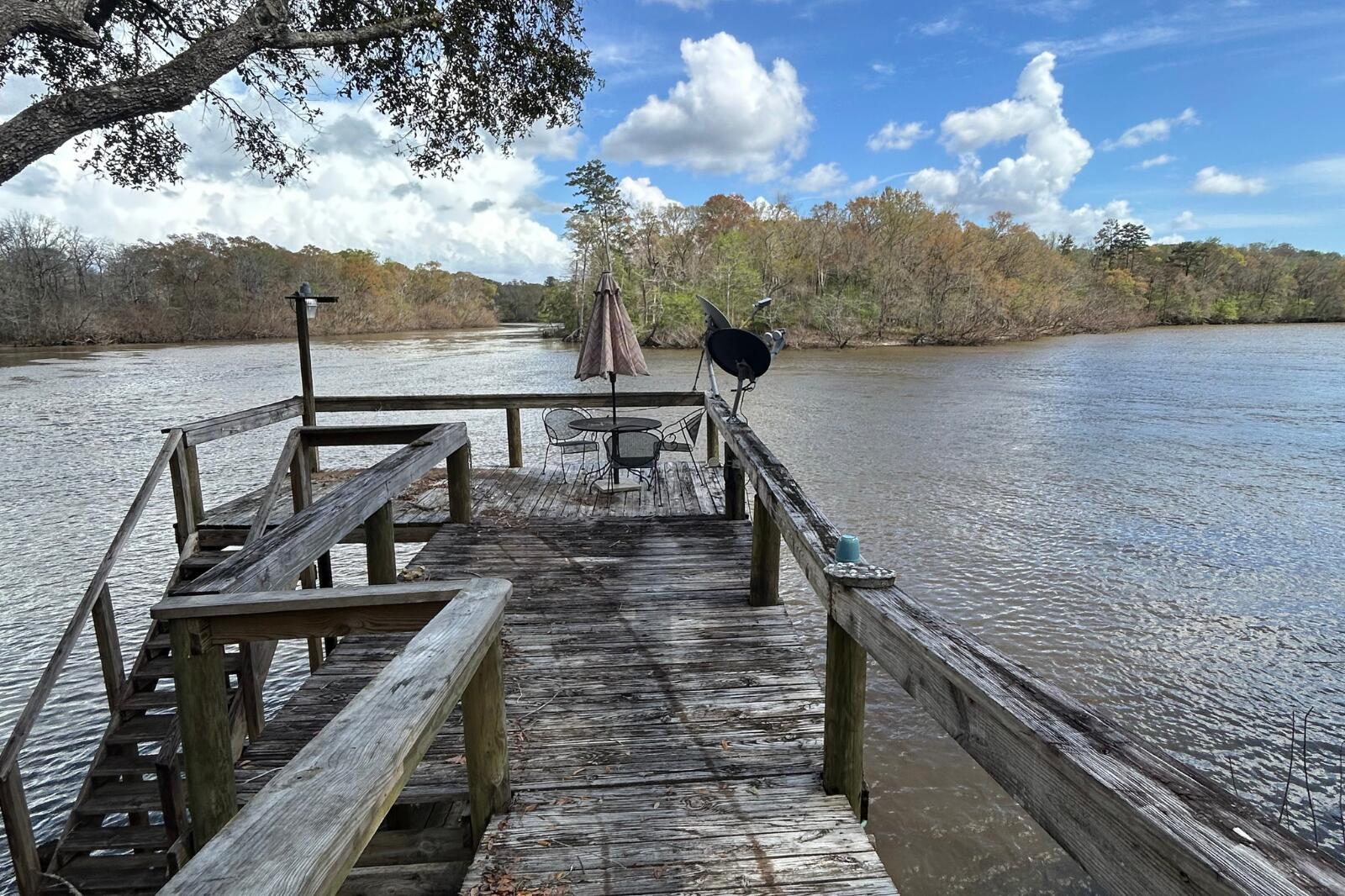 338 Howell Bluff Road Ponce de Leon, FL 32455 - Photo 5 of 8 a view of a balcony with wooden floor and lake view